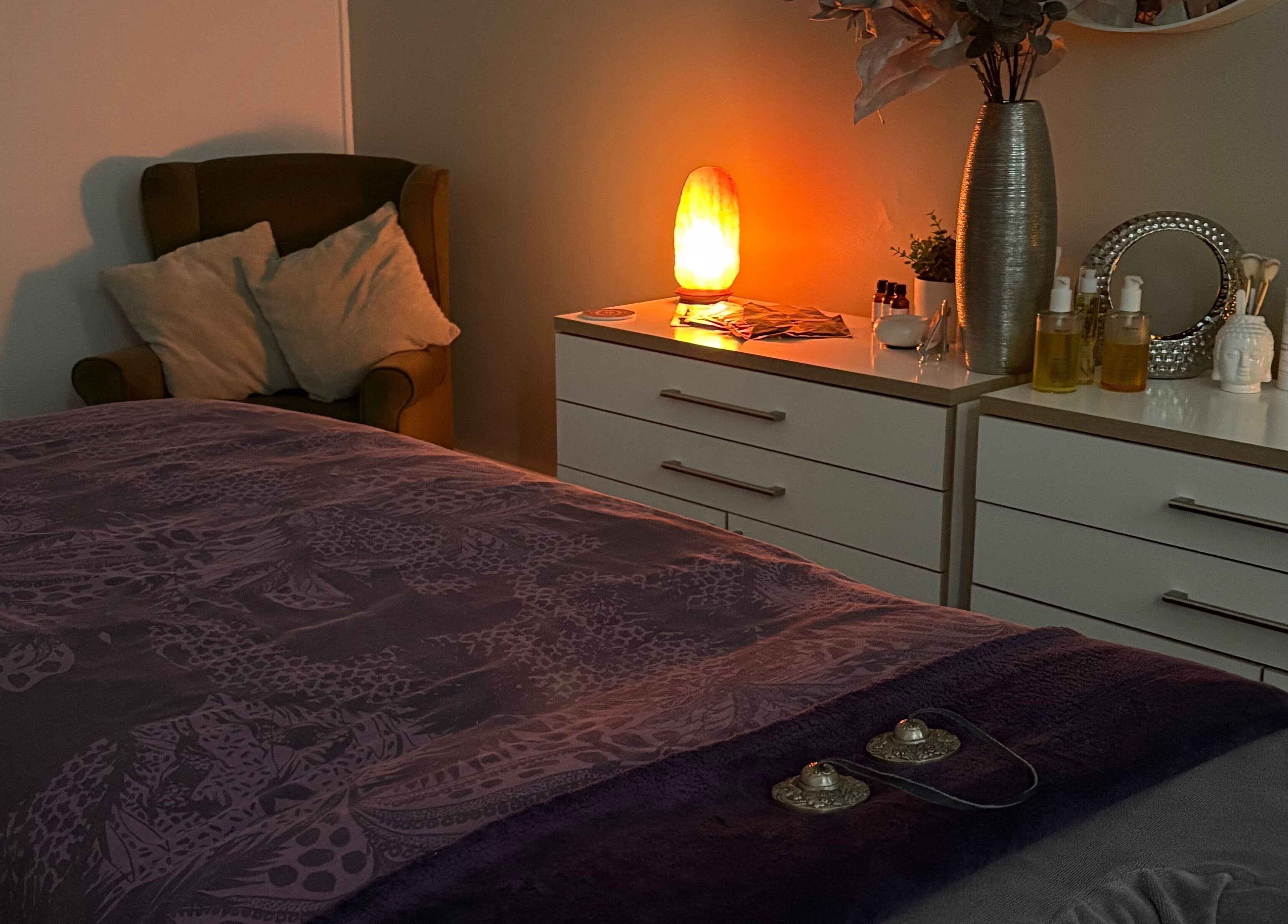 Cozy treatment room at Tranquility Holistic, Sarisbury Green, England, with warm lighting and plush décor.