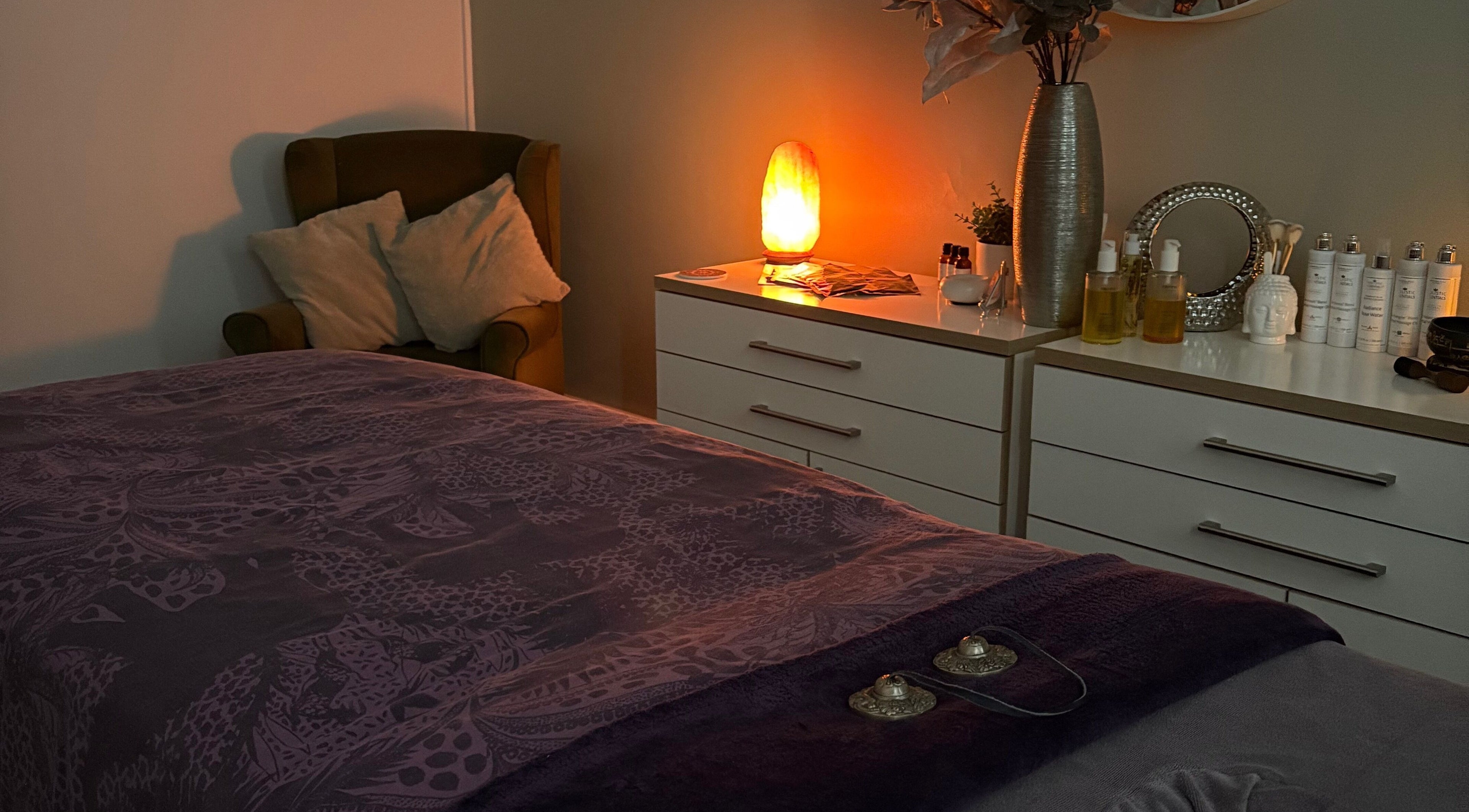 Cozy treatment room at Tranquility Holistic, Sarisbury Green, England, with warm lighting and plush décor.