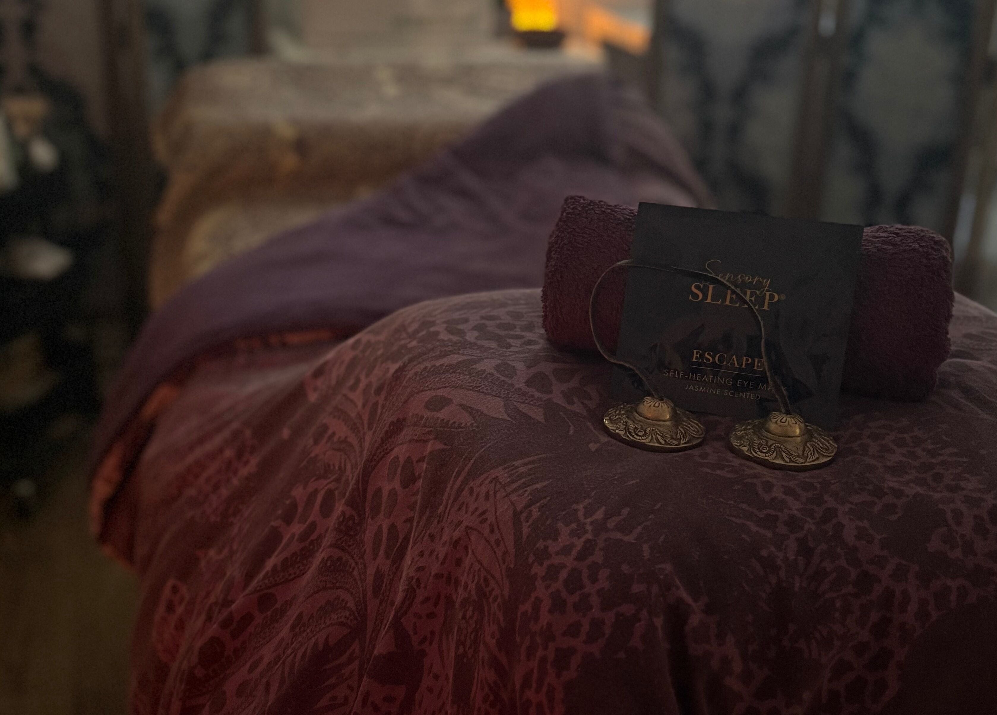 Relaxing spa setup at Tranquility Holistic, Sarisbury Green, England, GB, with purple linens and calming decor.