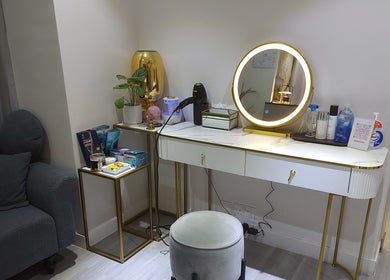 A chic vanity at Mima Skin at TST, 尖沙咀多福大廈2樓A室, HK, featuring a mirror, stool, and beauty products.