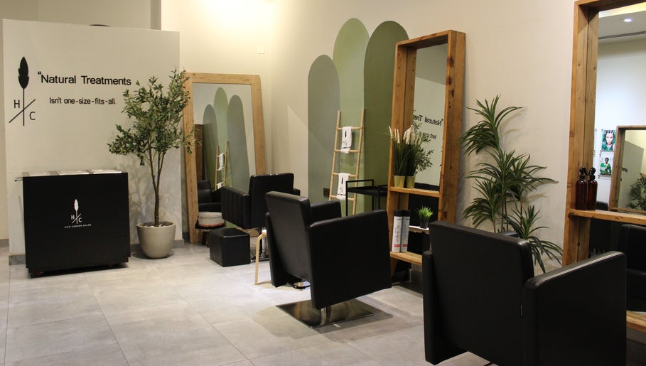 Relaxing interior of Hair Corner Salon in Dubai, Dubai, AE, featuring chic chairs and lush greenery.