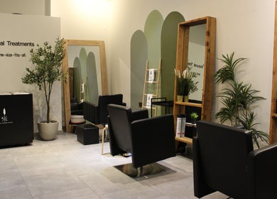 Relaxing interior of Hair Corner Salon in Dubai, Dubai, AE, featuring chic chairs and lush greenery.
