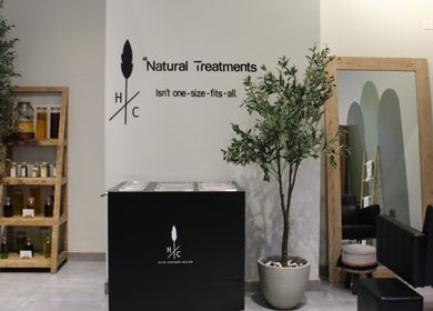 Interior of Hair Corner Salon in Dubai featuring plants, products, and stylish decor.