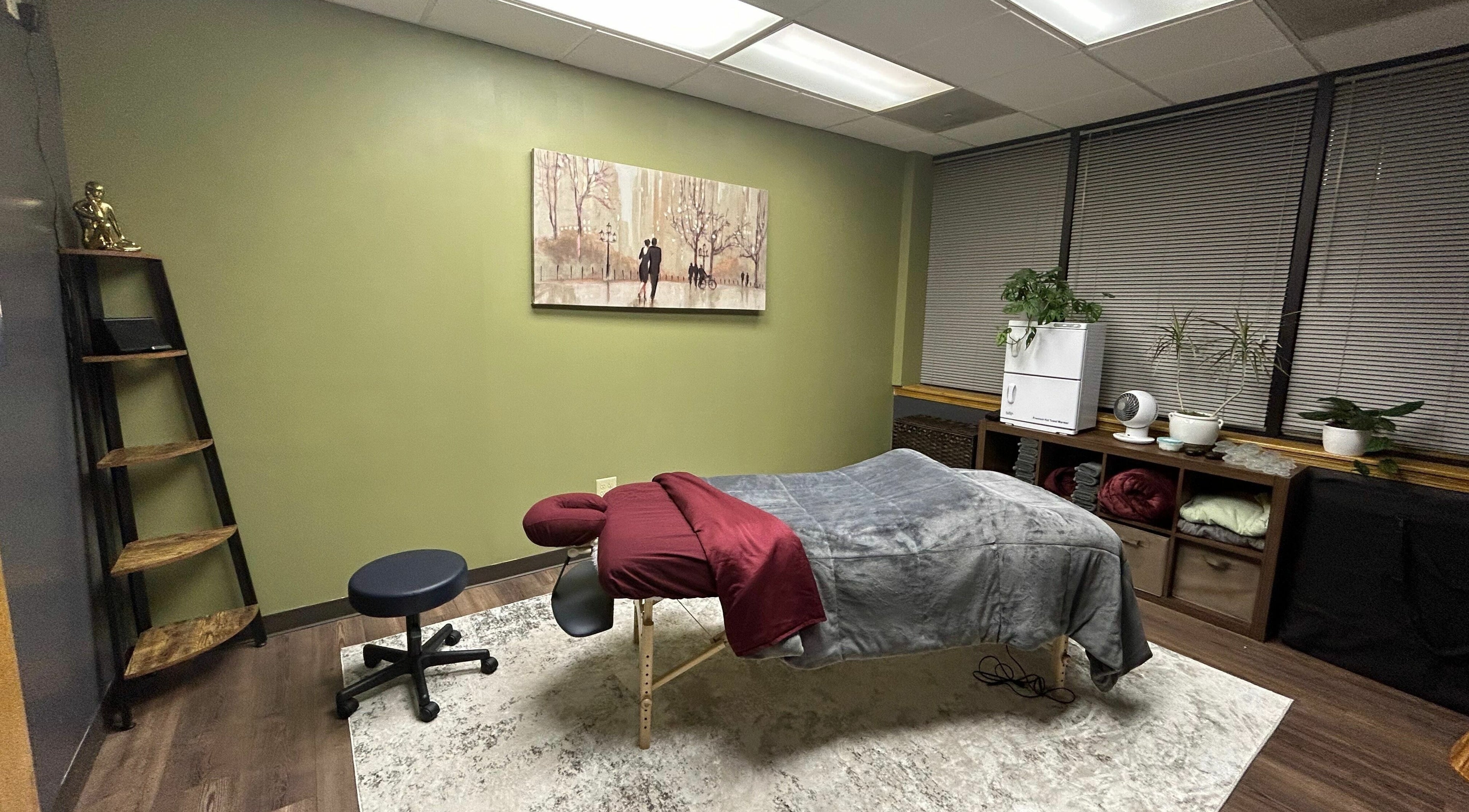 Green Life massage room with cozy table and decor in Lenexa, Kansas, US.