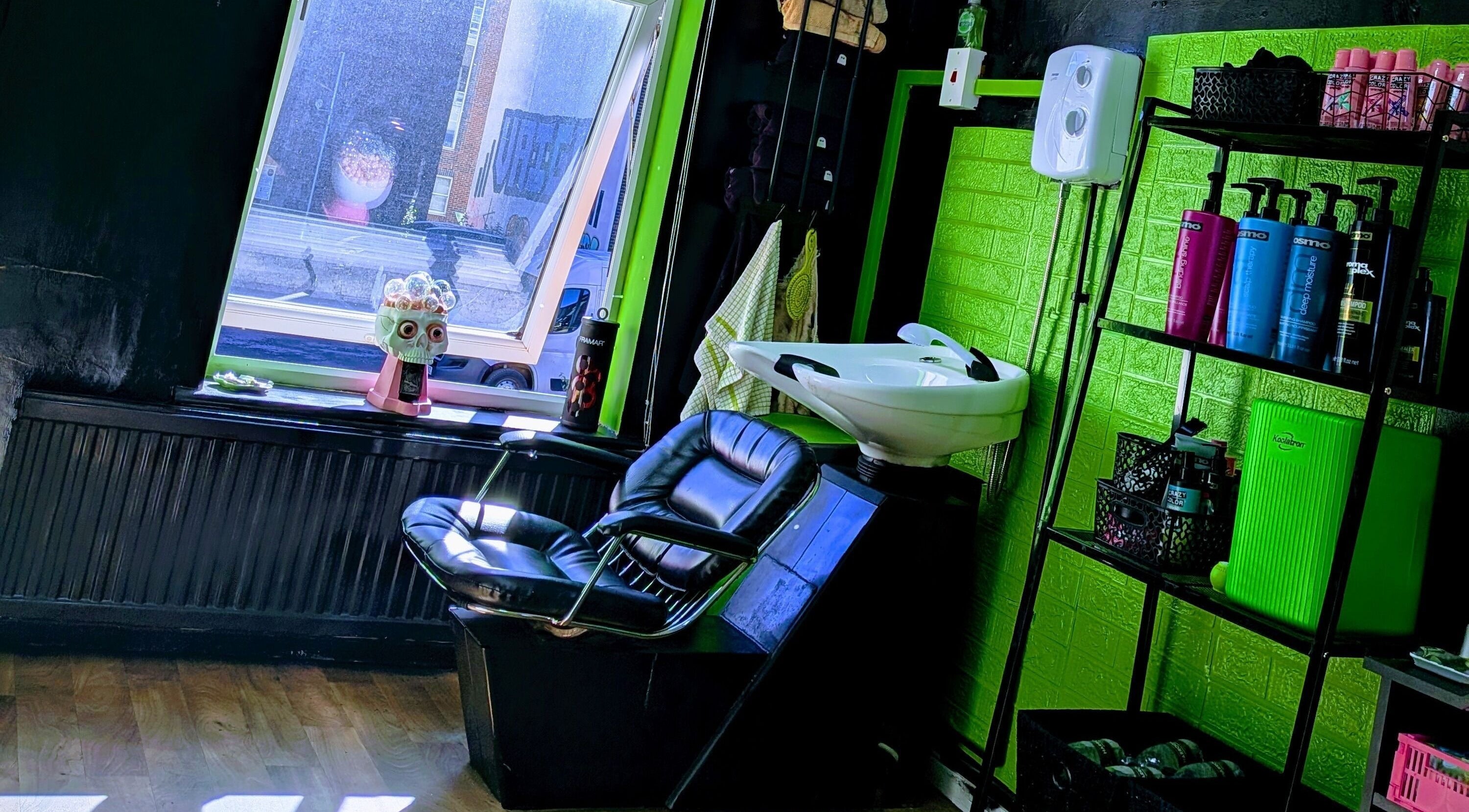 Chic salon interior at Red's Hairdressing, Swindon, England, GB, featuring a stylish wash station.