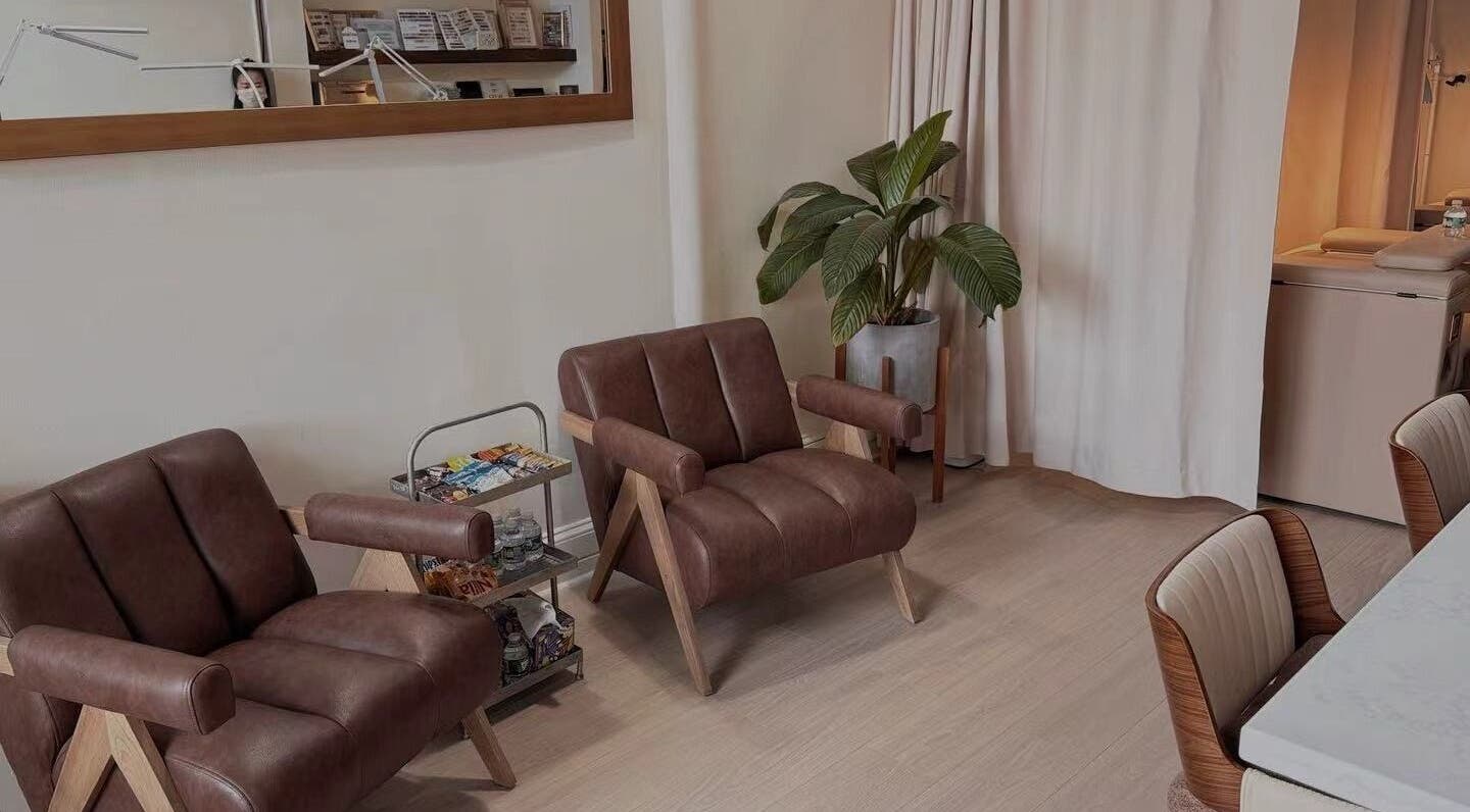 Comfortable seating area at Miss Rainbow Nails Lounge in Boston, Massachusetts, US with leather chairs and modern decor.