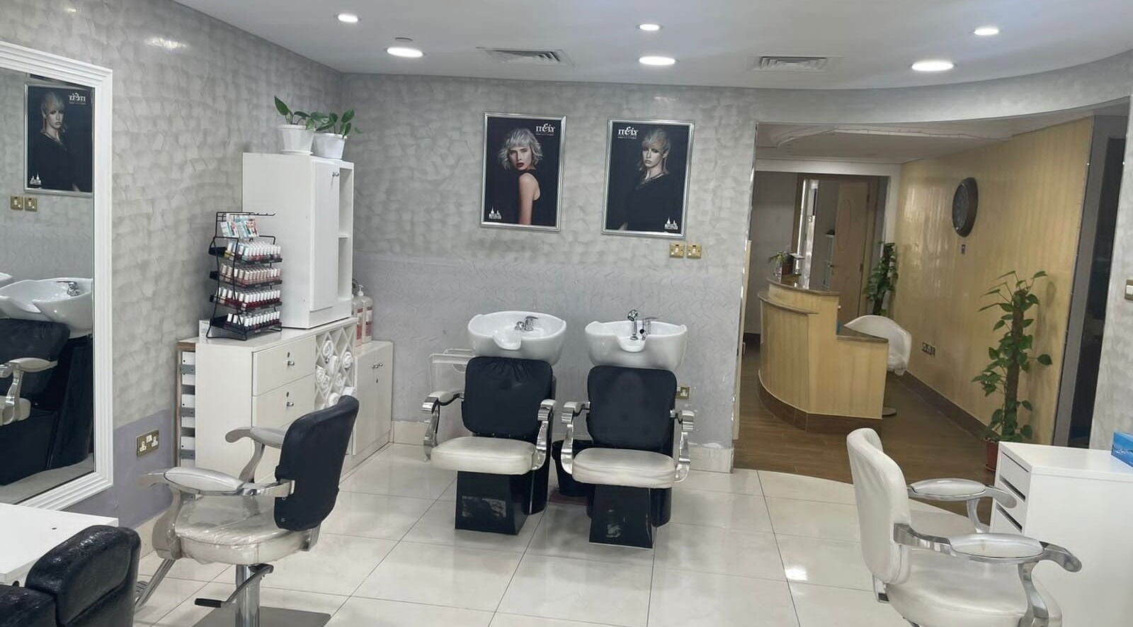 Interior of Hajir Ladies Salon with styling chairs and washbasins, located in Abu Dhabi, AE.