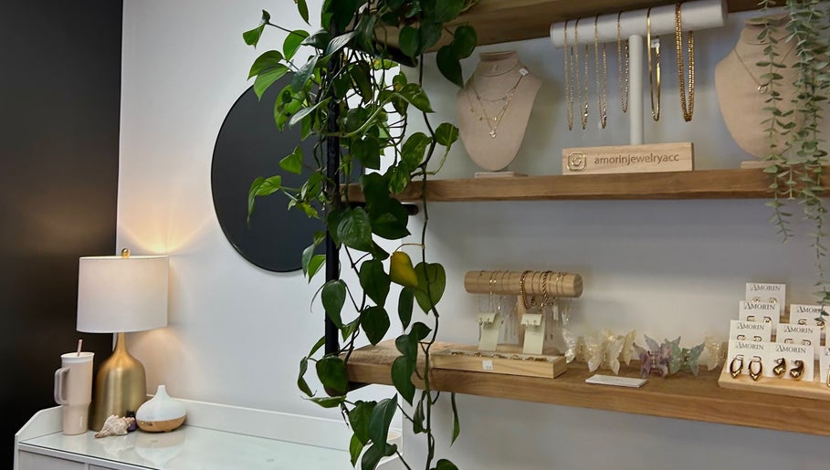 Elegant jewelry display shelves at Xoéy Nail Artistry, St. Albert, Alberta, CA featuring hanging plants and accessories.