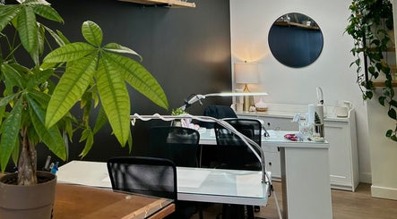 Stylish interior of Xoéy Nail Artistry in St. Albert, Alberta, CA with modern decor and greenery.