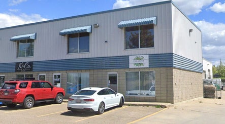 Exterior view of Xoéy Nail Artistry in St. Albert, Alberta, CA, showcasing a modern building with parked cars.