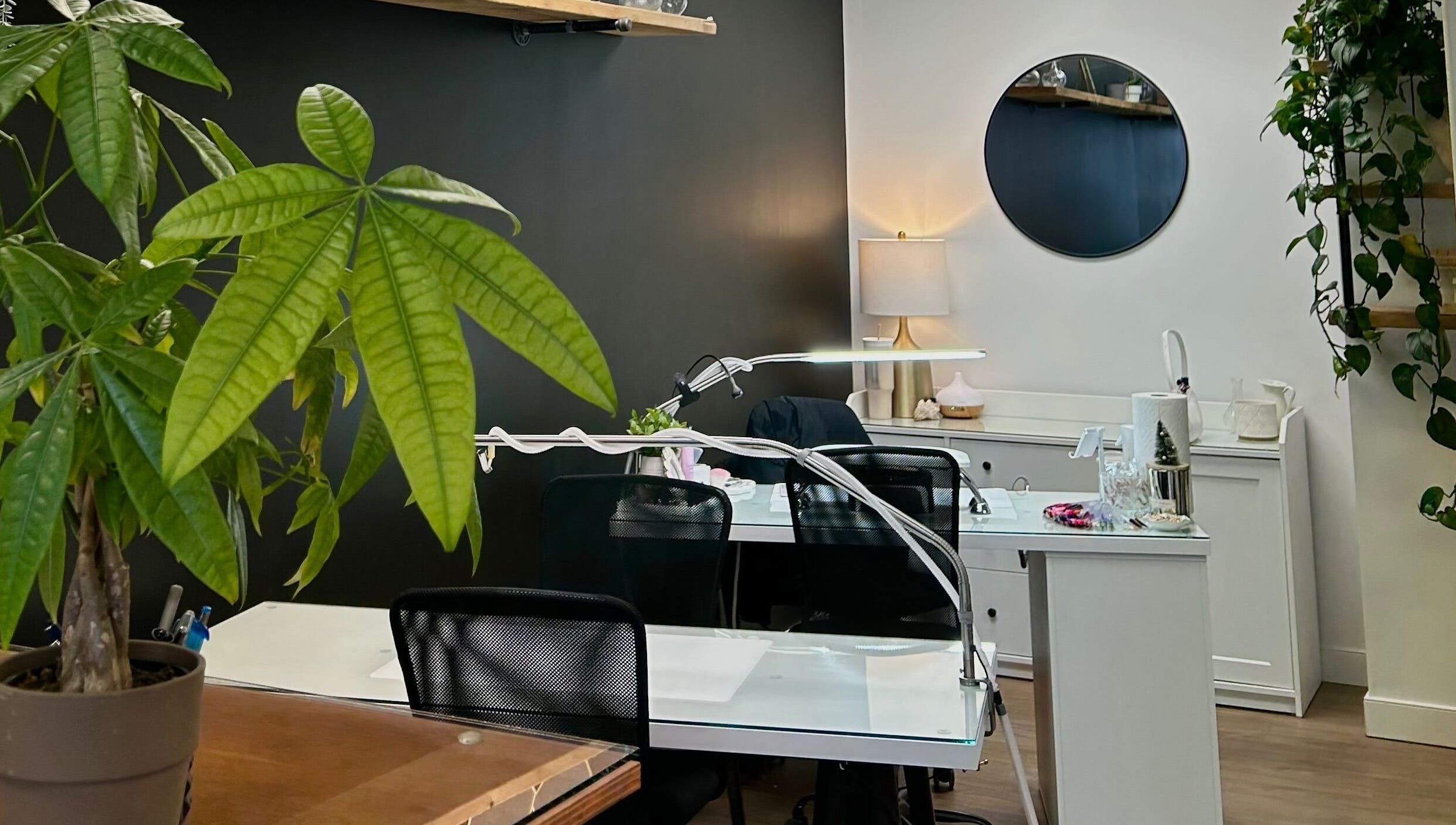 Elegant nail workstations with greenery at Xoéy Nail Artistry, St. Albert, Alberta, CA.