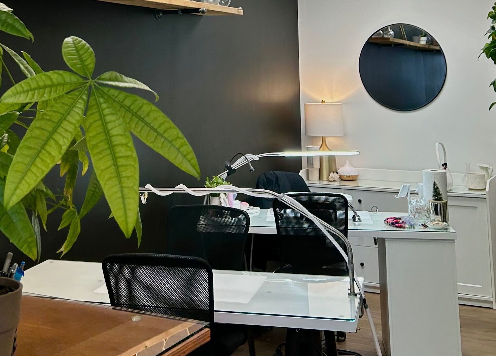 Elegant nail workstations with greenery at Xoéy Nail Artistry, St. Albert, Alberta, CA.