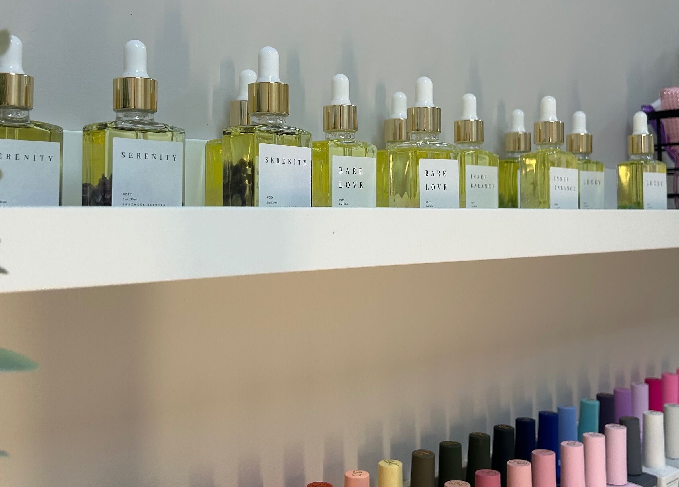 Display of Serenity oils and vibrant nail polishes at Xoéy Nail Artistry in St. Albert, Alberta, CA.