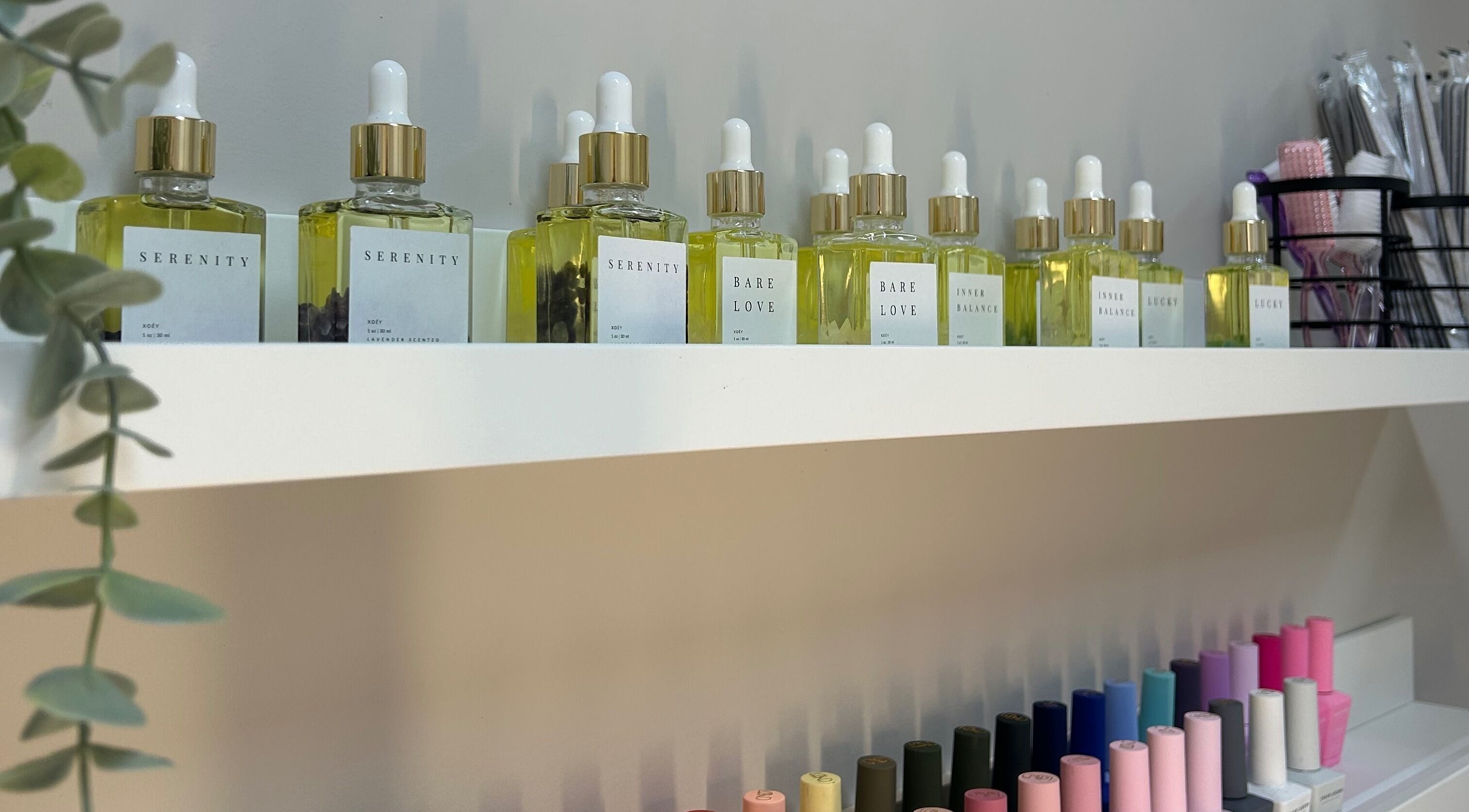 Display of Serenity oils and vibrant nail polishes at Xoéy Nail Artistry in St. Albert, Alberta, CA.