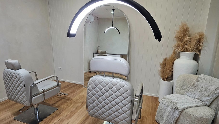 Elegant salon chair at Studio SMP Gold Coast in Bundall, Queensland, AU with cozy decor and modern lighting.