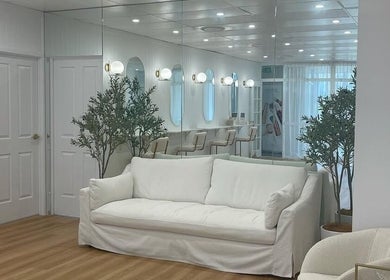 Comfortable seating area at Studio SMP Gold Coast in Bundall, Queensland, AU, with chic decor and bright lighting.