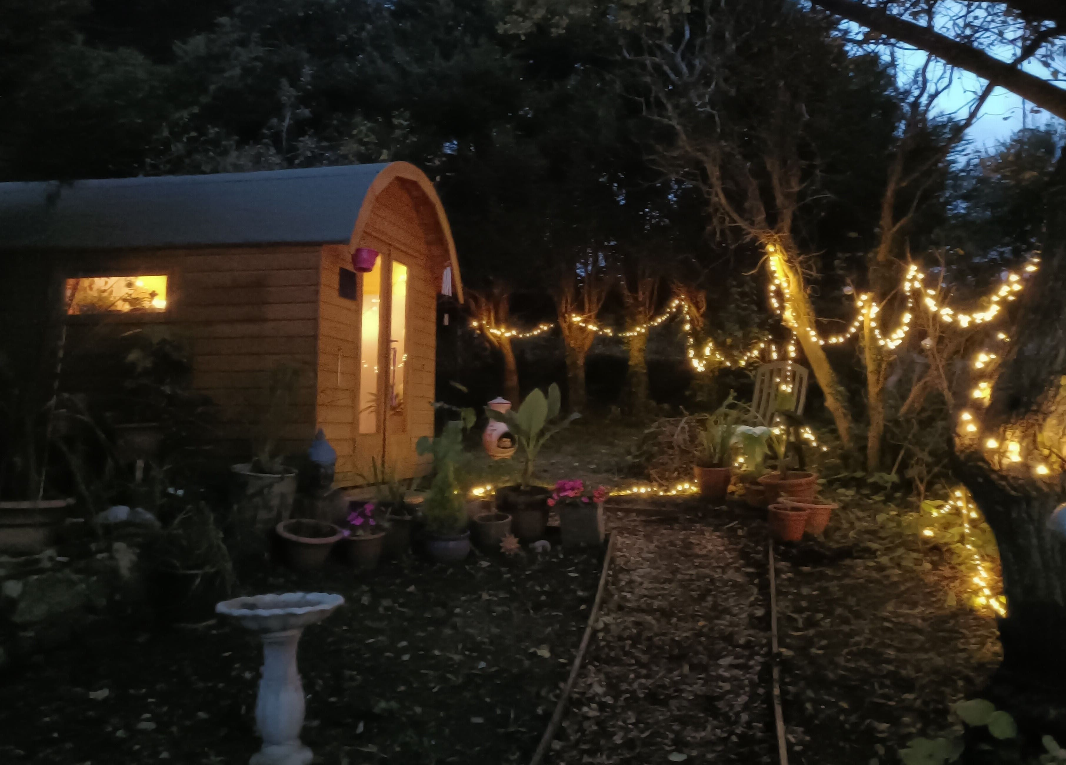 Night view of Hayle Cornish Holistic Therapies with glowing fairy lights in Hayle, GB.