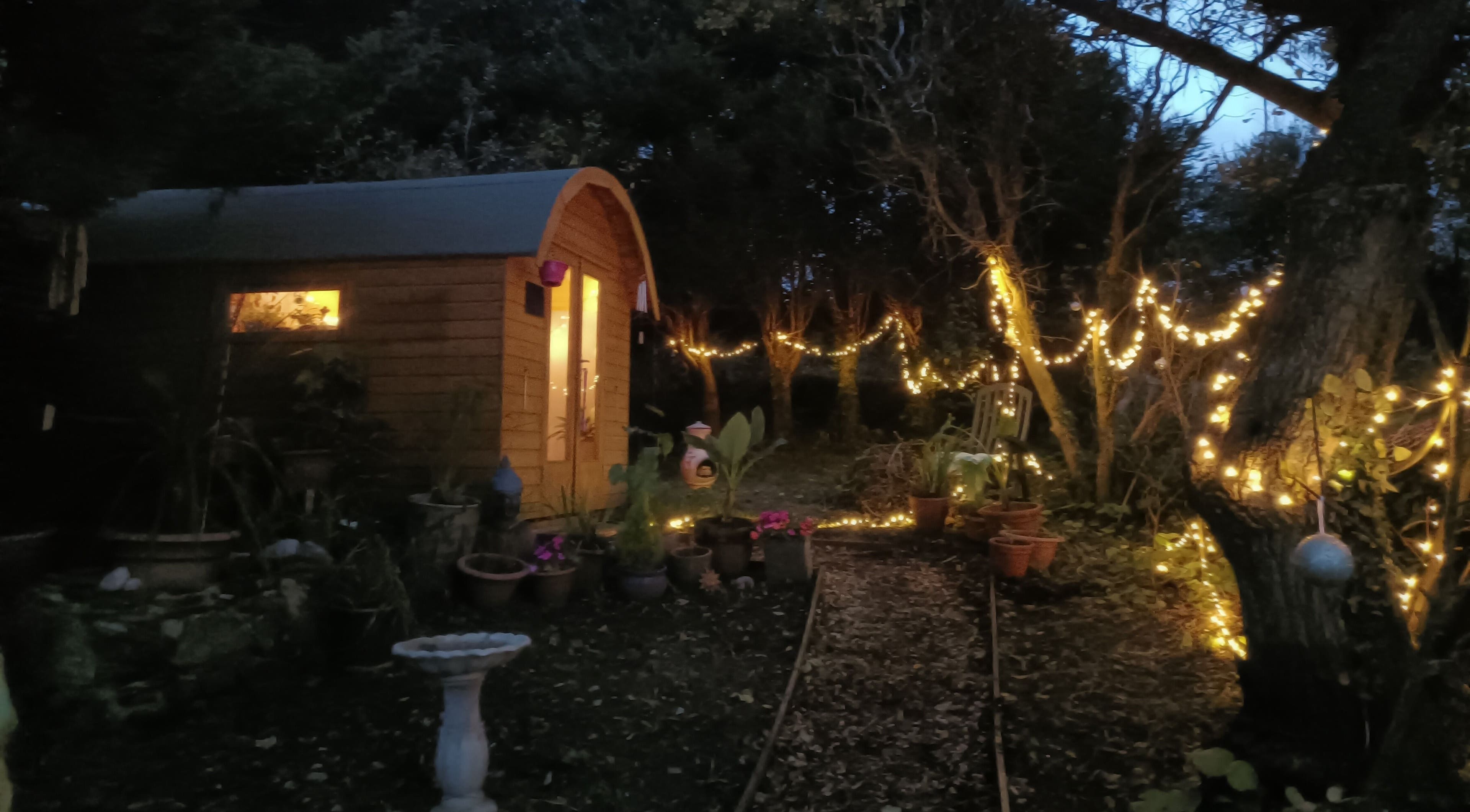 Night view of Hayle Cornish Holistic Therapies with glowing fairy lights in Hayle, GB.