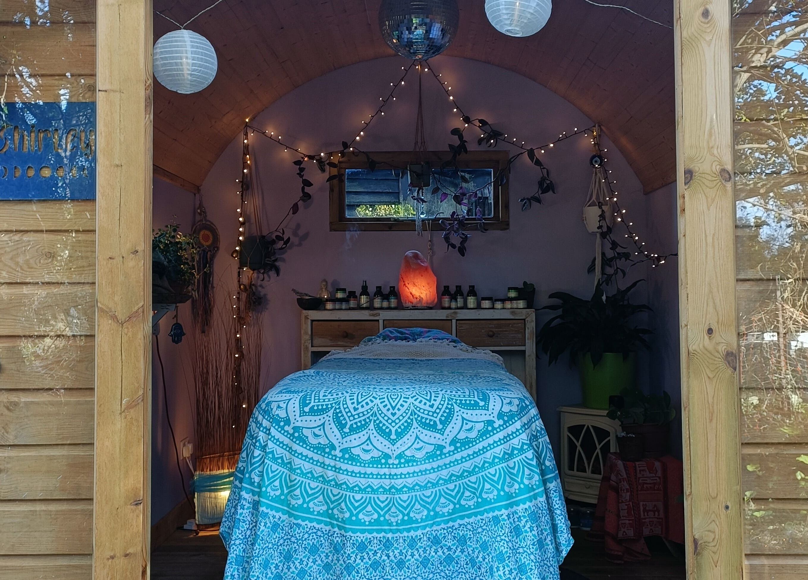 Cozy therapy room at Hayle Cornish Holistic Therapies in Hayle, GB with ambient lighting and massage table.