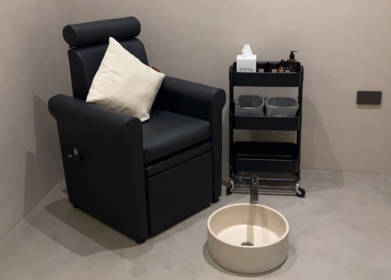 Luxurious pedicure station at Twig, Sharjah, AE with a plush chair and foot spa setup.