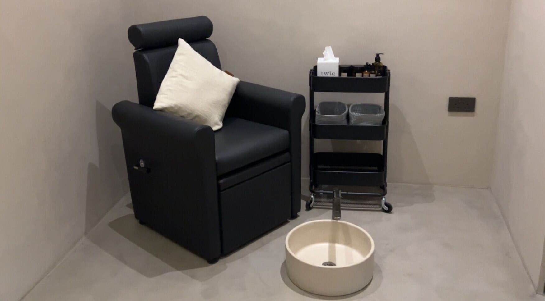 Luxurious pedicure station at Twig, Sharjah, AE with a plush chair and foot spa setup.