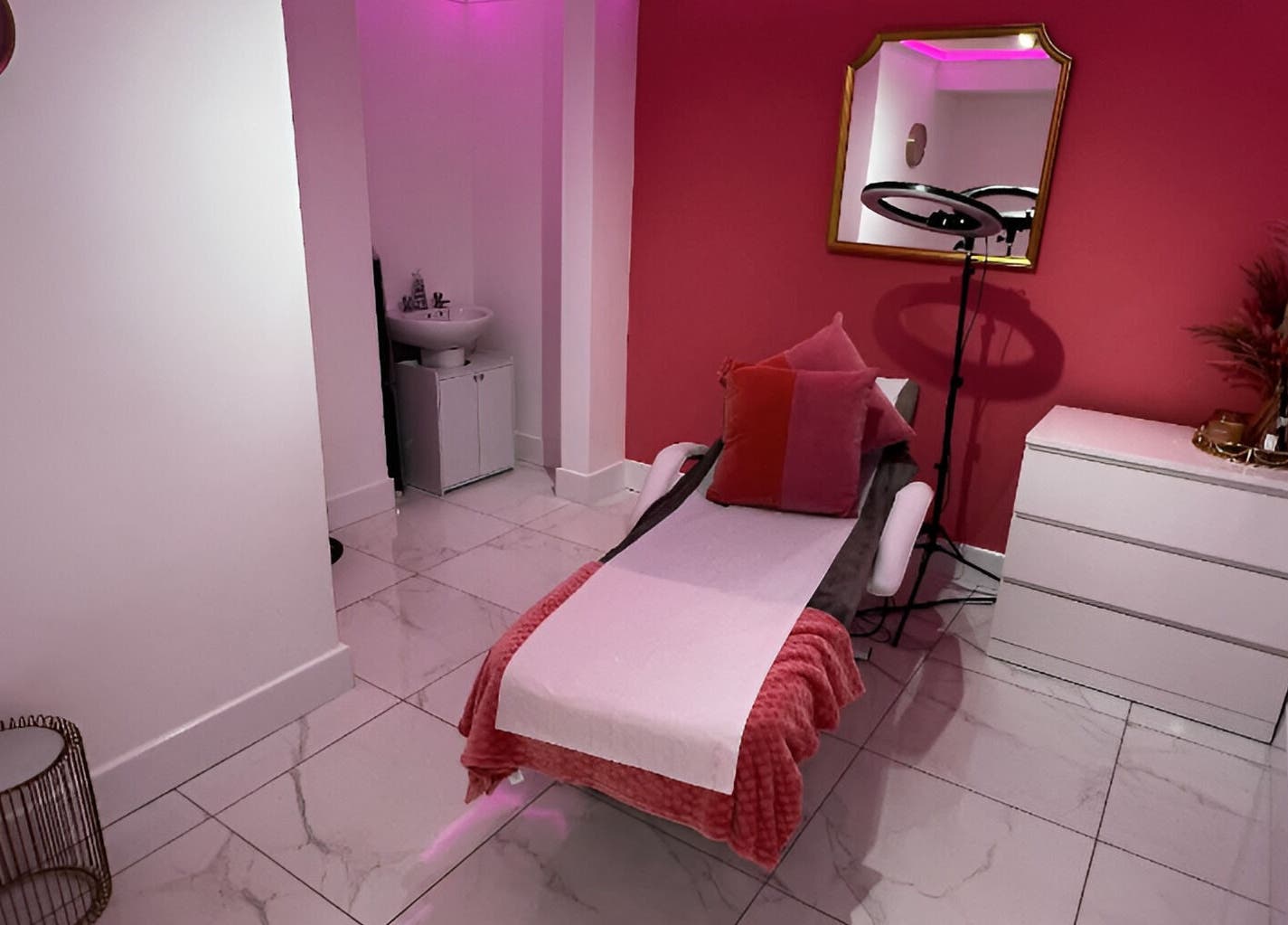 Relaxing treatment room at Tanella Beauty, Gateshead, England, GB, featuring a comfortable treatment bed and warm decor.