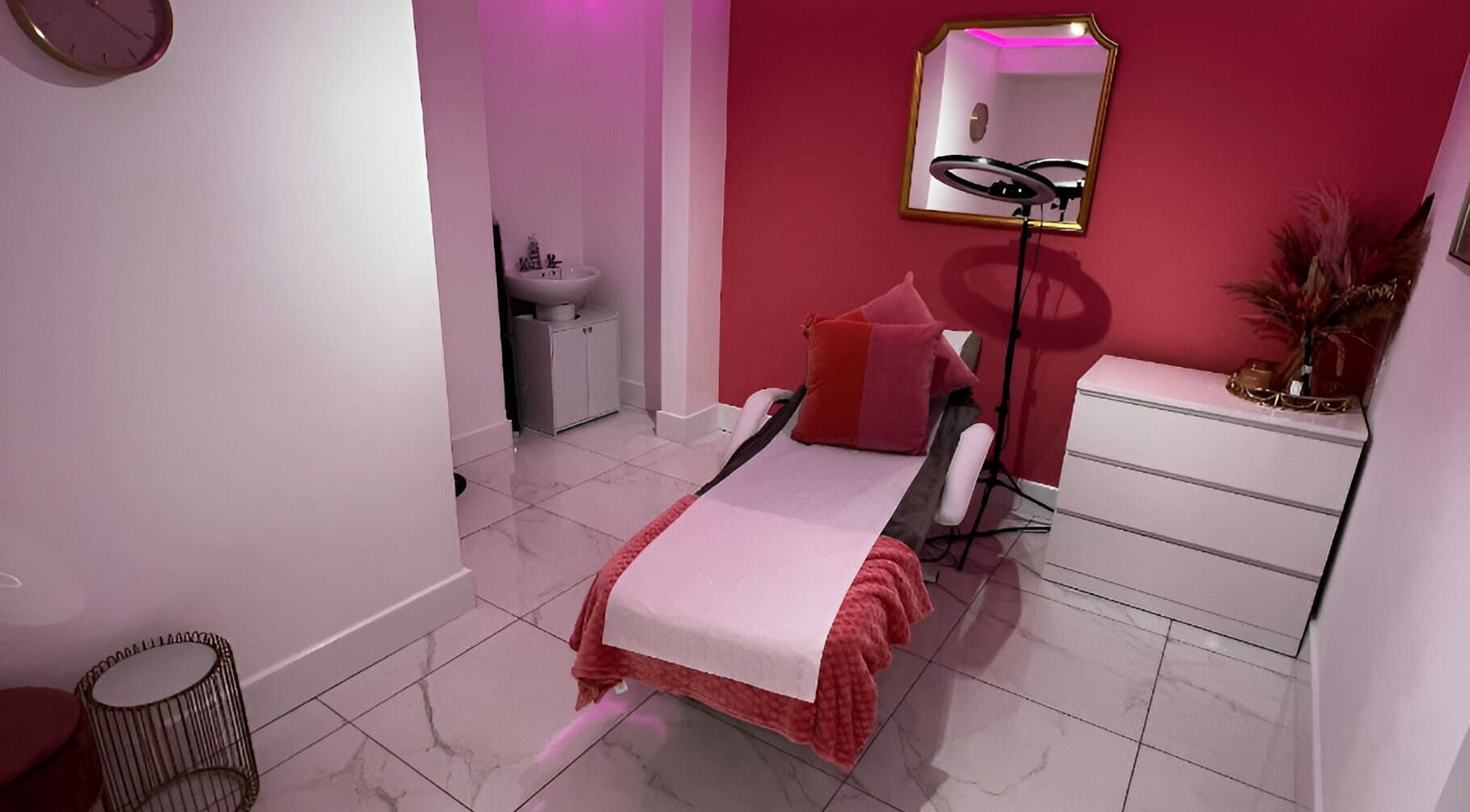Relaxing treatment room at Tanella Beauty, Gateshead, England, GB, featuring a comfortable treatment bed and warm decor.