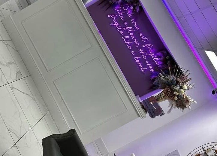Sophisticated reception at Tanella Beauty, Gateshead, England, GB with neon sign and floral decor.