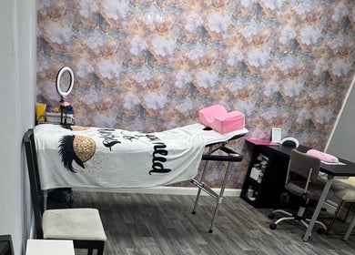 Relaxing treatment room at Lavish Beauty & Aesthetics, Castleford, England, GB with elegant decor and massage table.
