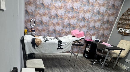 Relaxing treatment room at Lavish Beauty & Aesthetics, Castleford, England, GB with elegant decor and massage table.