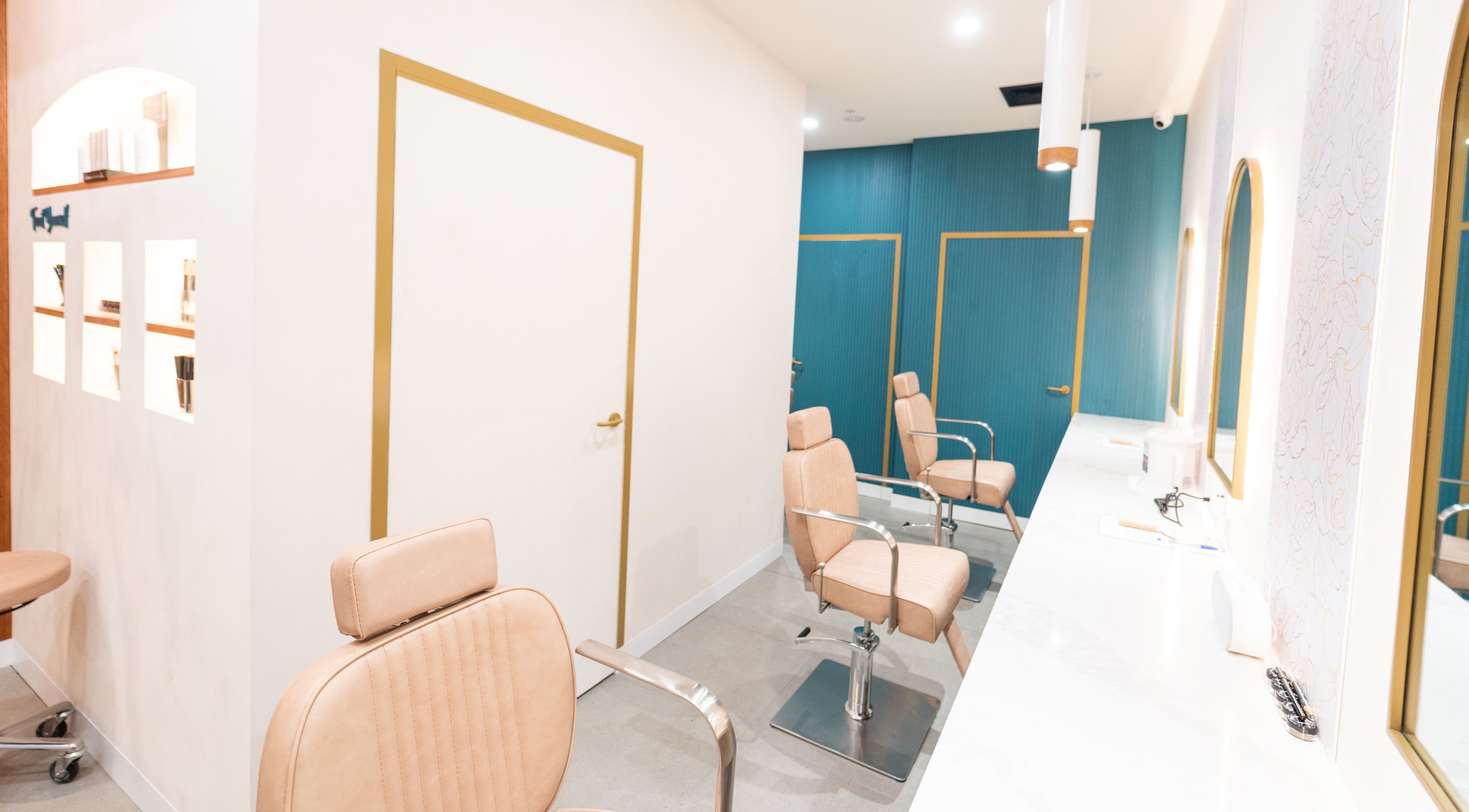 Modern interior of Just Brows & Beauty, Adelaide, South Australia. Elegant salon chairs and mirrors line the space.