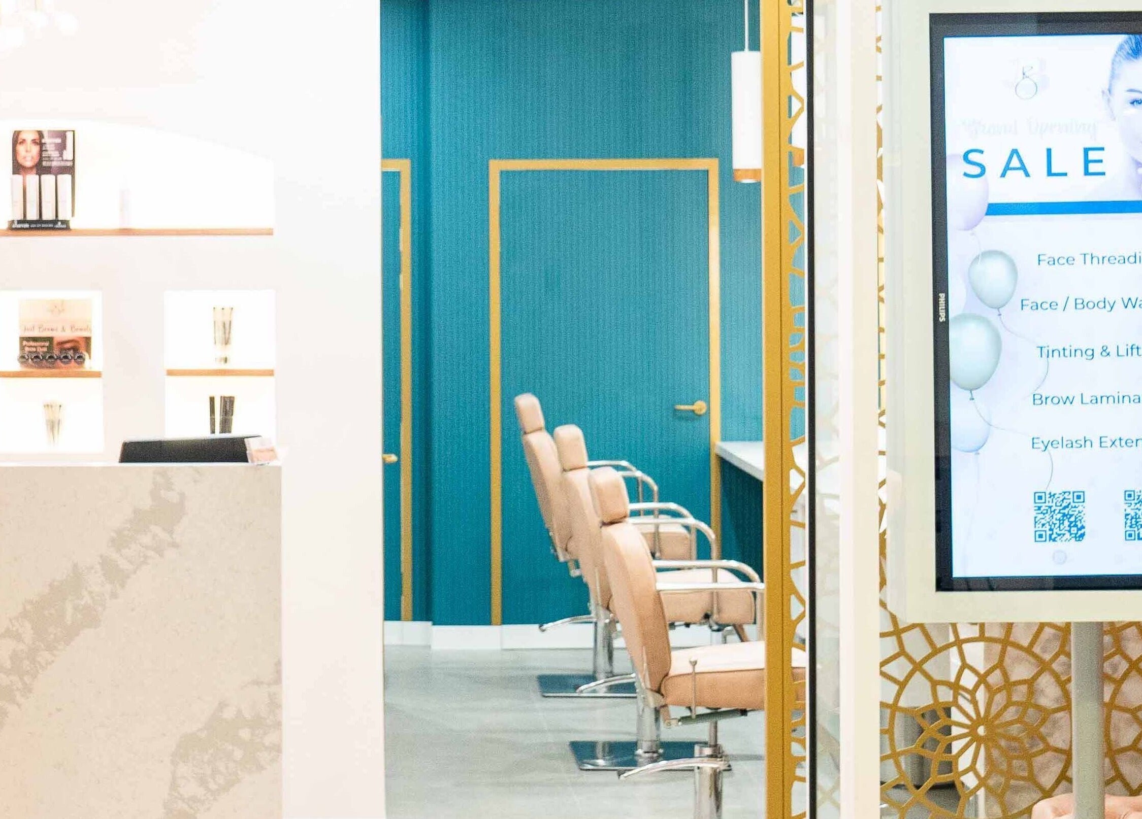 Inside Just Brows & Beauty, Adelaide, South Australia with chic decor and service offerings displayed.