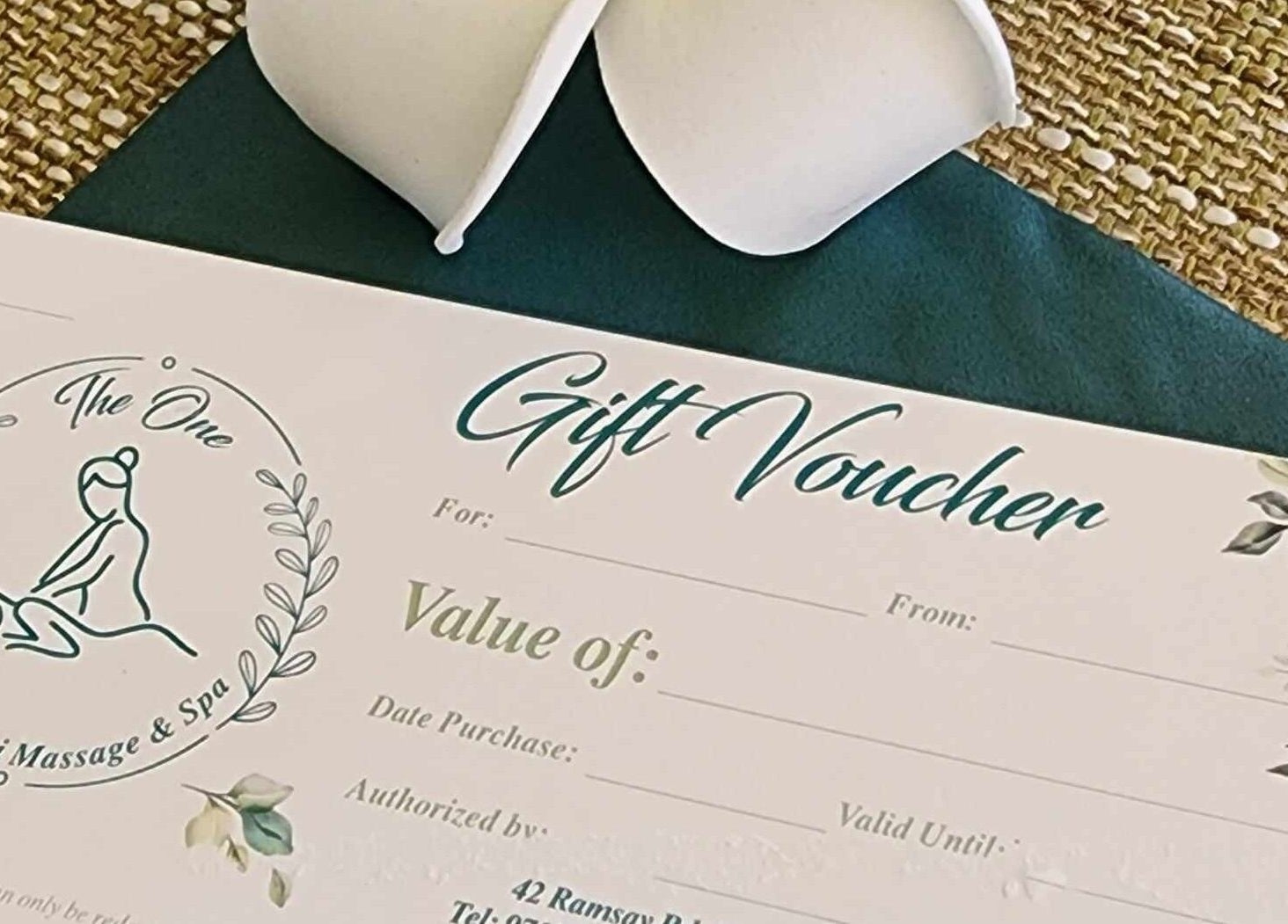 Gift voucher at The One Remedial Massage and Spa Five Dock, New South Wales, AU on a woven mat.