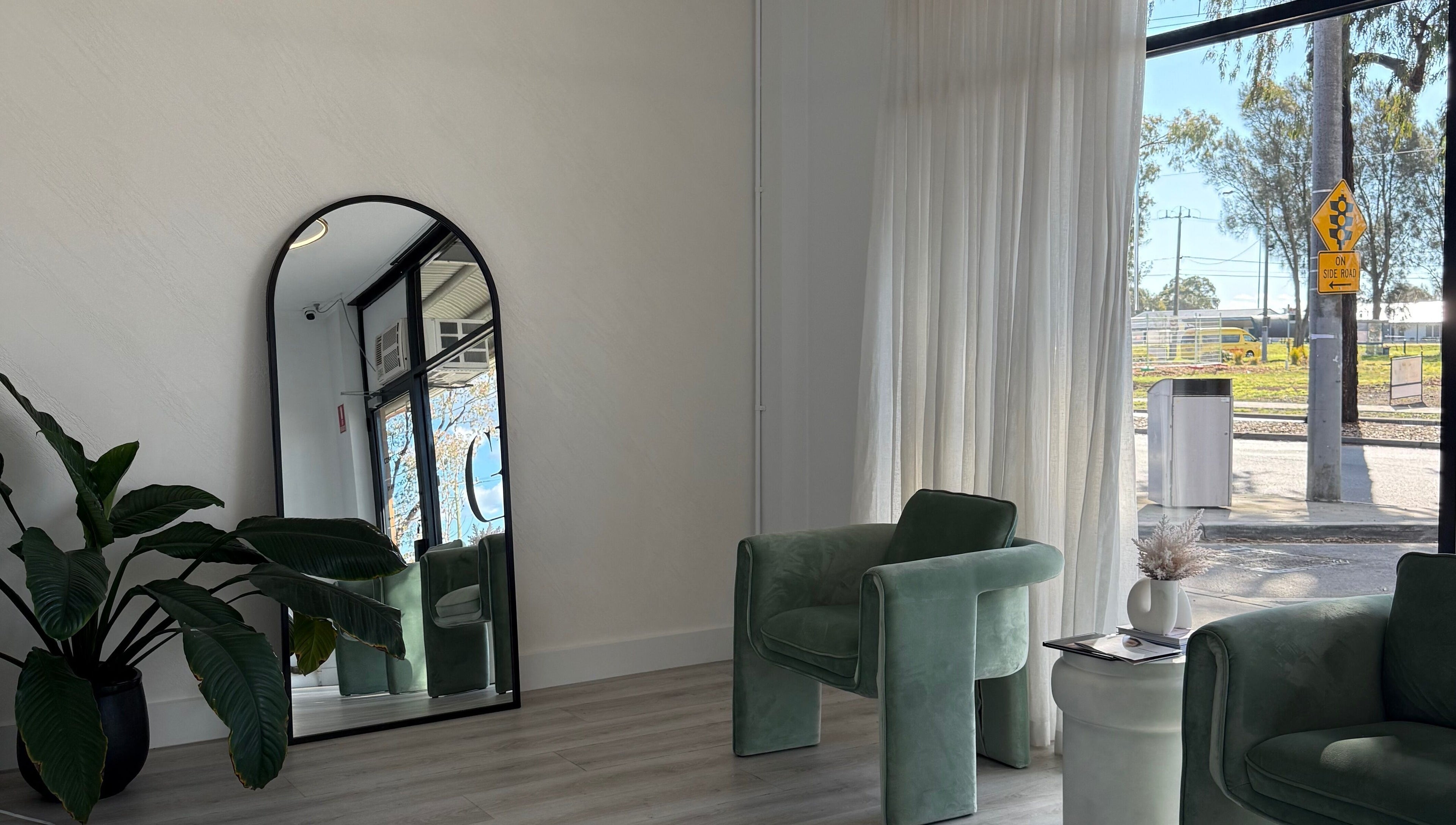 Chic waiting area at Cosmetic Effects, Ivanhoe, Victoria, AU, featuring lush plants and stylish seating.