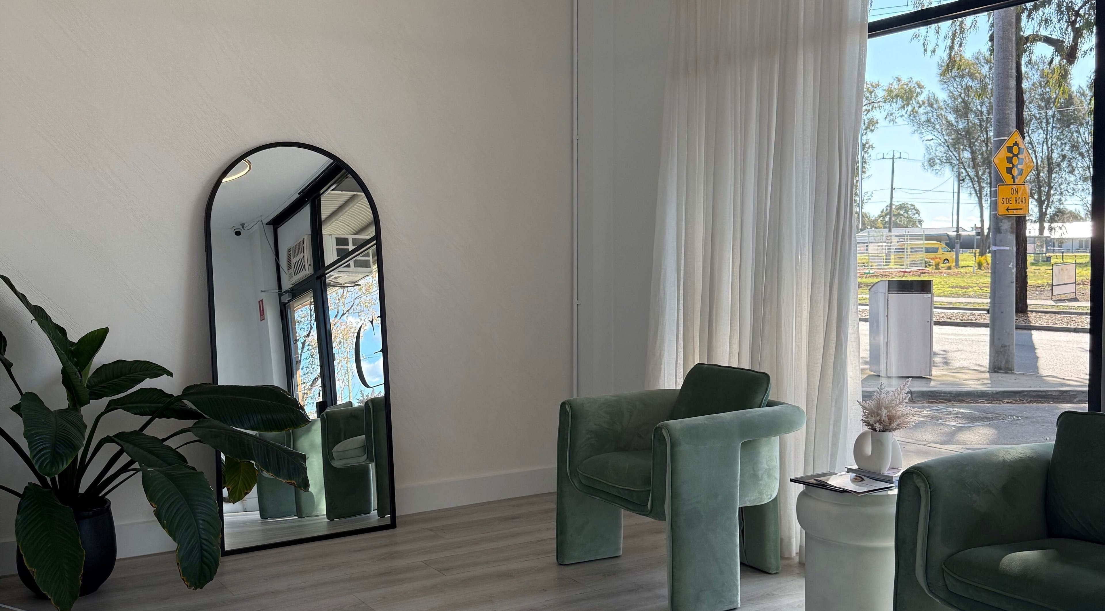 Chic waiting area at Cosmetic Effects, Ivanhoe, Victoria, AU, featuring lush plants and stylish seating.