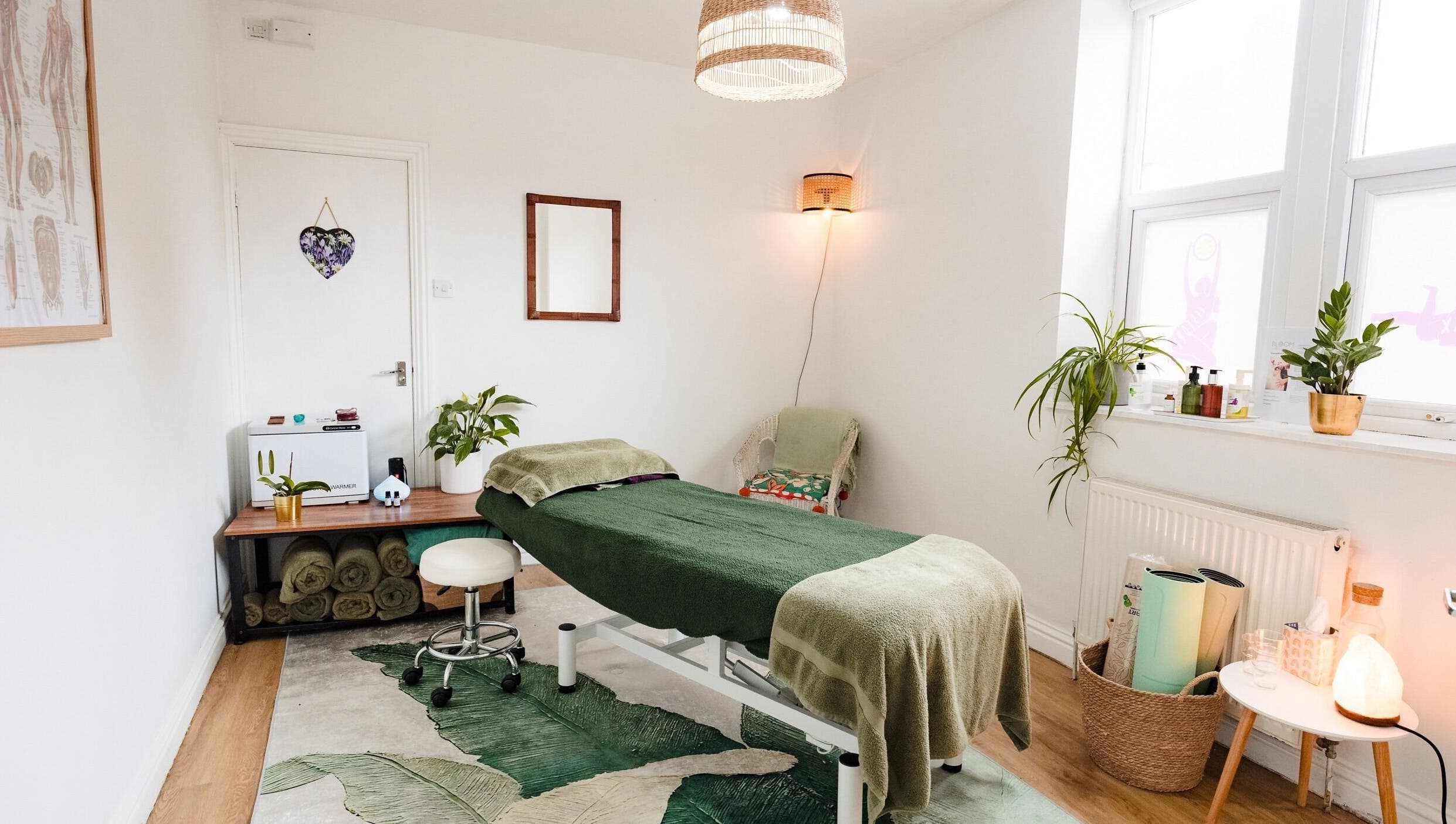 Tranquil therapy room at Bloom Well Being, Newcastle upon Tyne, England, GB, with spa table and plants.