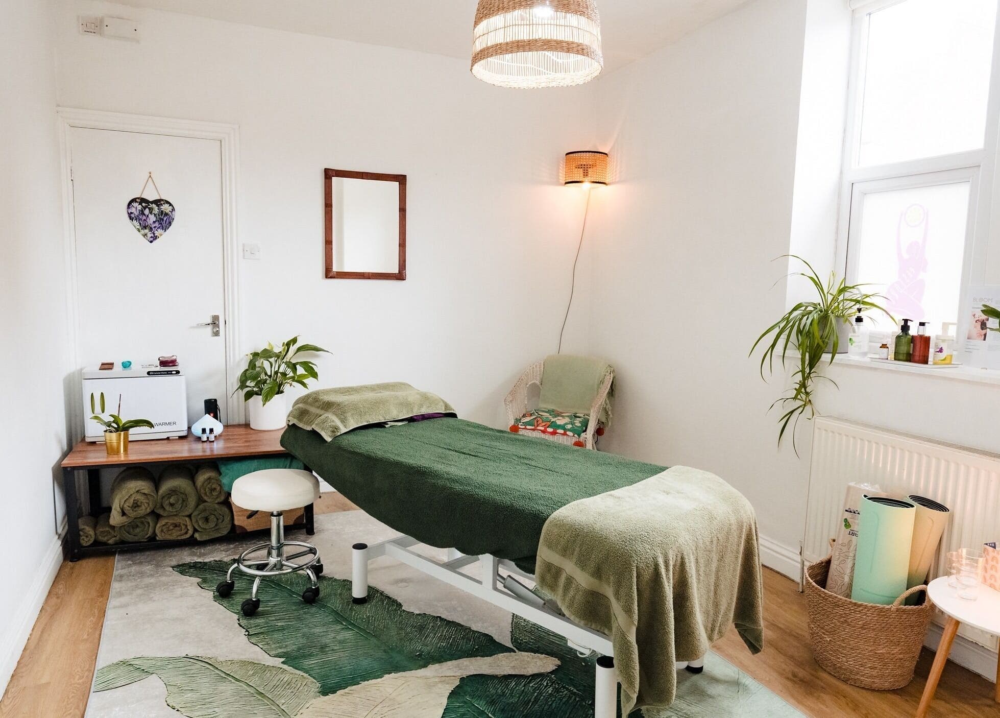 Tranquil therapy room at Bloom Well Being, Newcastle upon Tyne, England, GB, with spa table and plants.