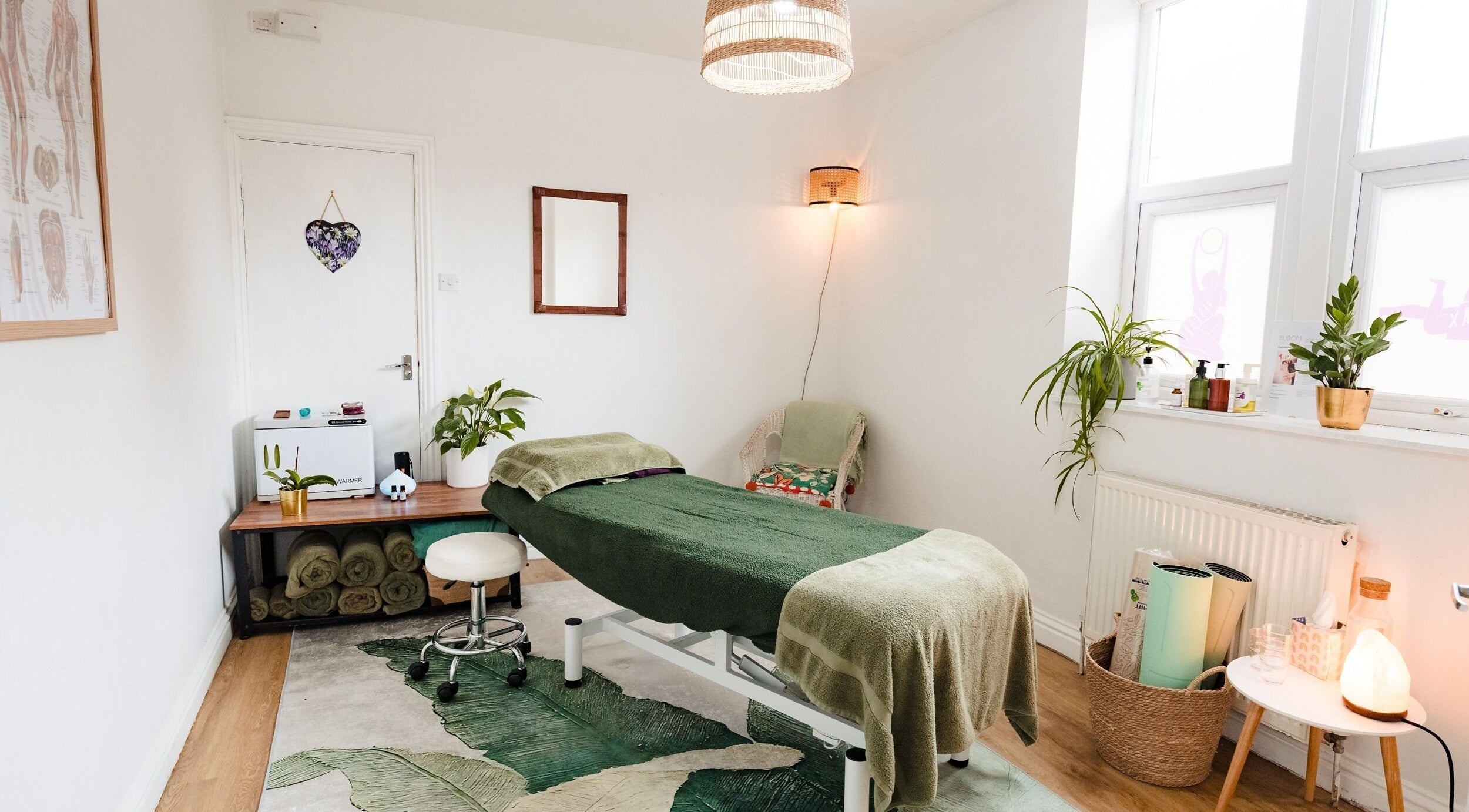 Tranquil therapy room at Bloom Well Being, Newcastle upon Tyne, England, GB, with spa table and plants.