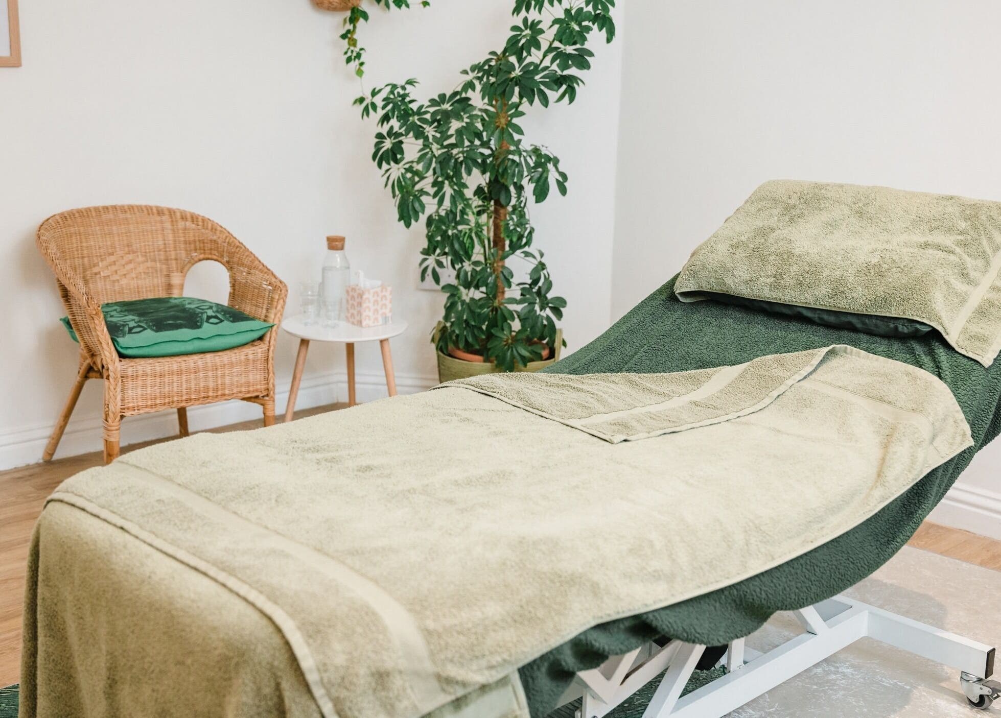 Relaxing treatment room at Bloom Well Being, Newcastle upon Tyne, England, GB with cozy decor and greenery.