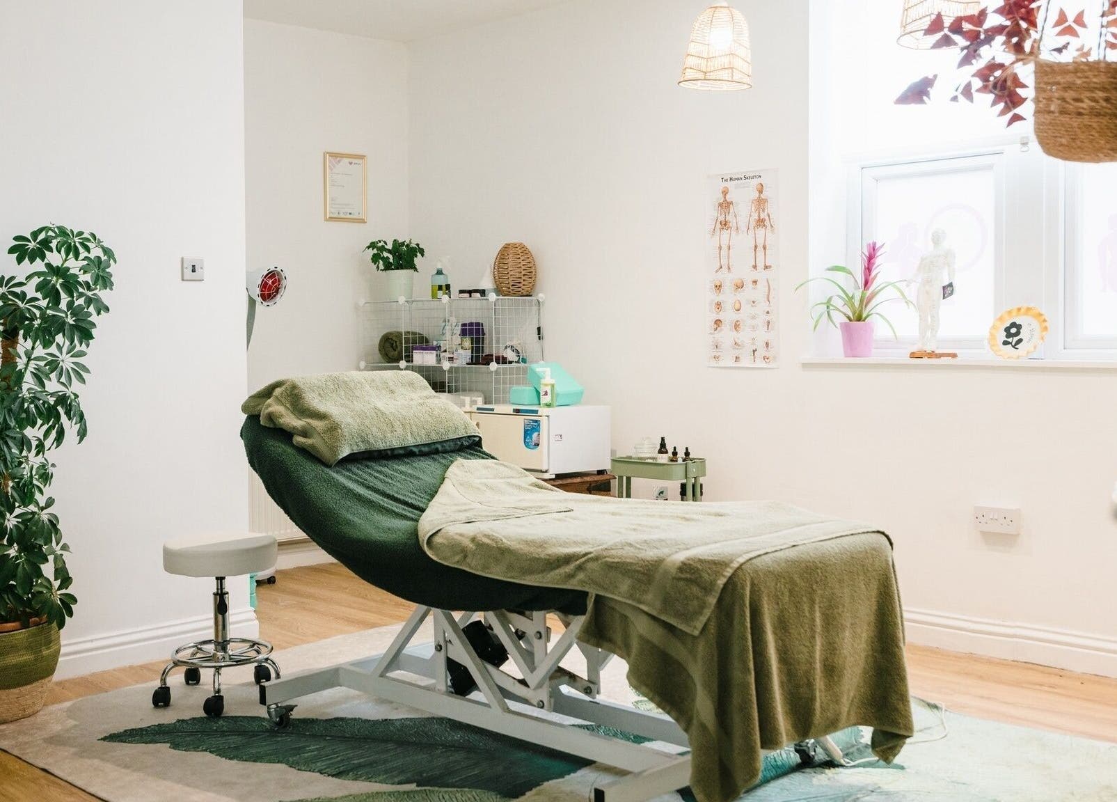 Relaxing therapy room at Bloom Well Being, Newcastle upon Tyne, England, GB, with a cozy treatment bed.