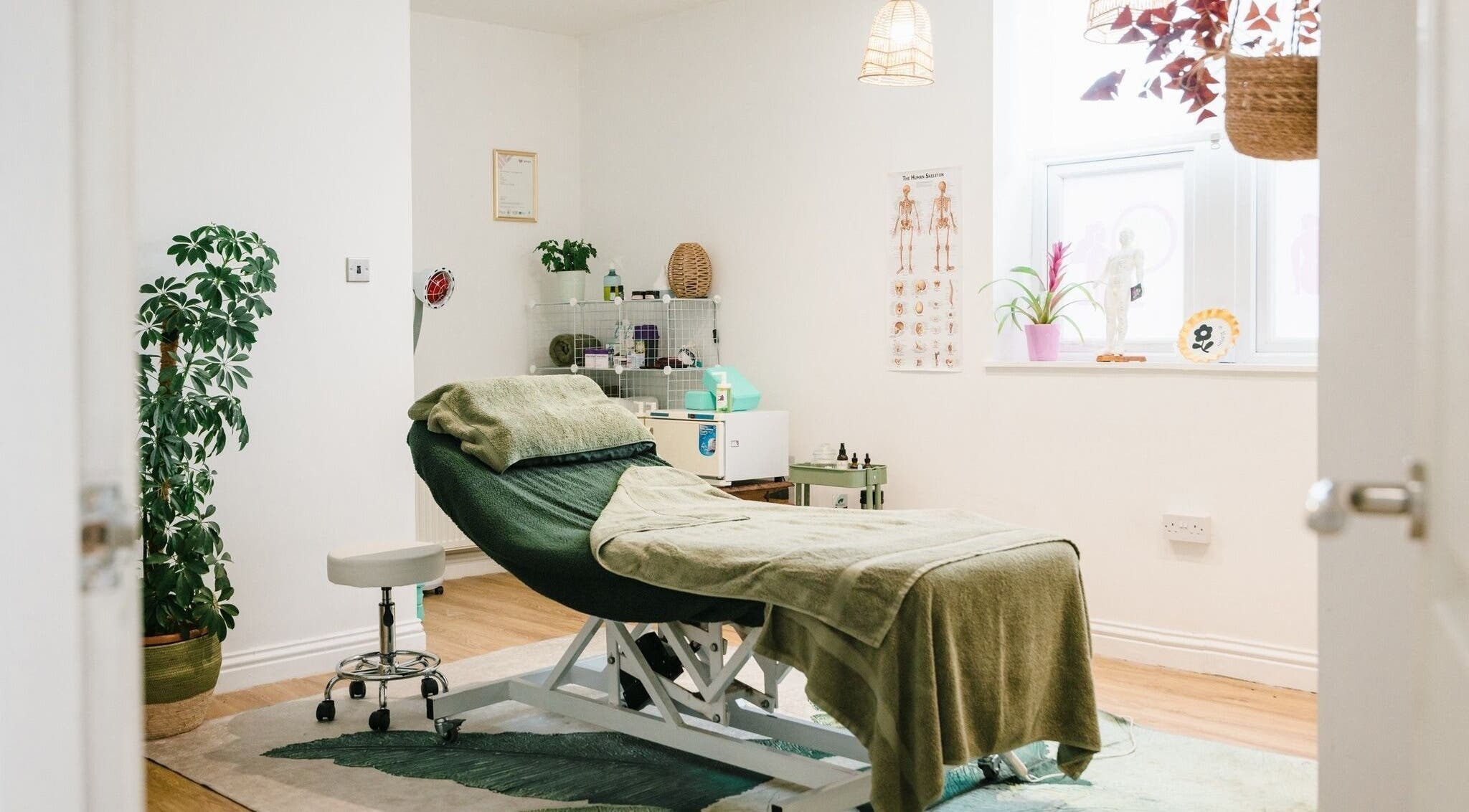 Relaxing therapy room at Bloom Well Being, Newcastle upon Tyne, England, GB, with a cozy treatment bed.