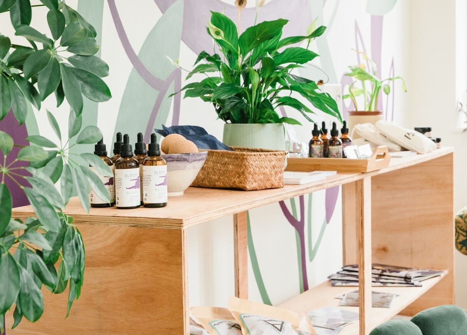 Natural wellness products displayed at Bloom Well Being, Newcastle upon Tyne, England, GB. Lush plants decorate the space.