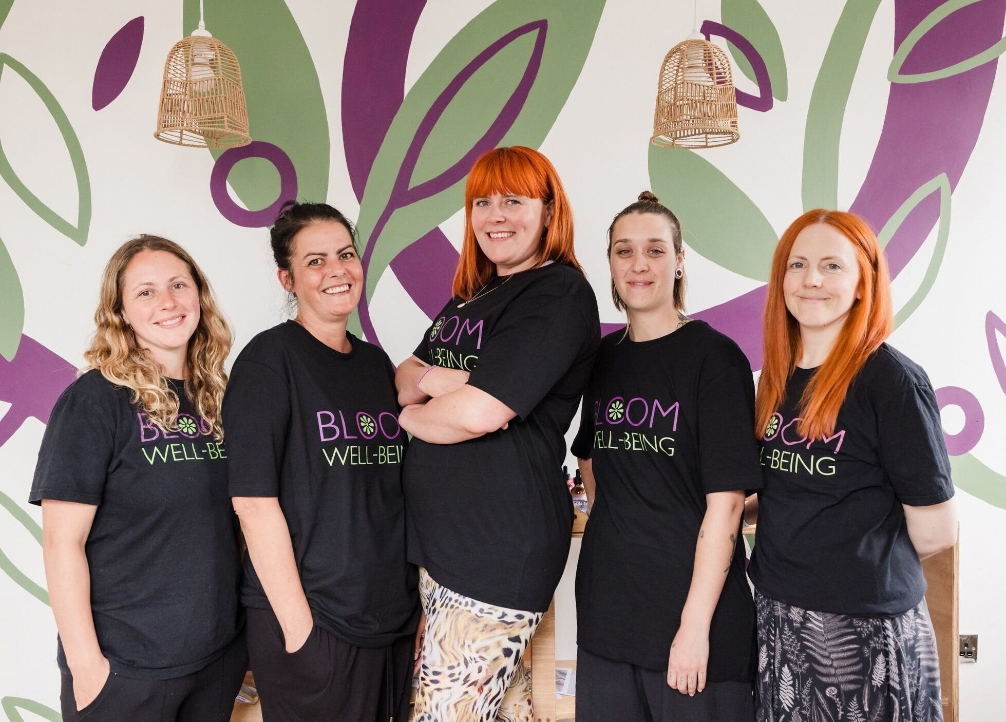 Team of Bloom Well Being staff posing happily in vibrant setting, Newcastle upon Tyne, England, GB.