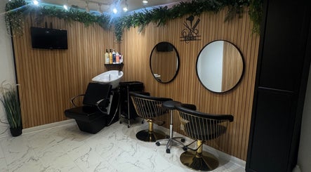 Elegant salon interior at HairHQ in Maidstone, England, GB showing washing station and mirrors.