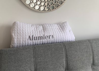 Elegant couch with a white quilt at The Peel Queen, Addlestone, England, GB. Perfect wellness ambiance.