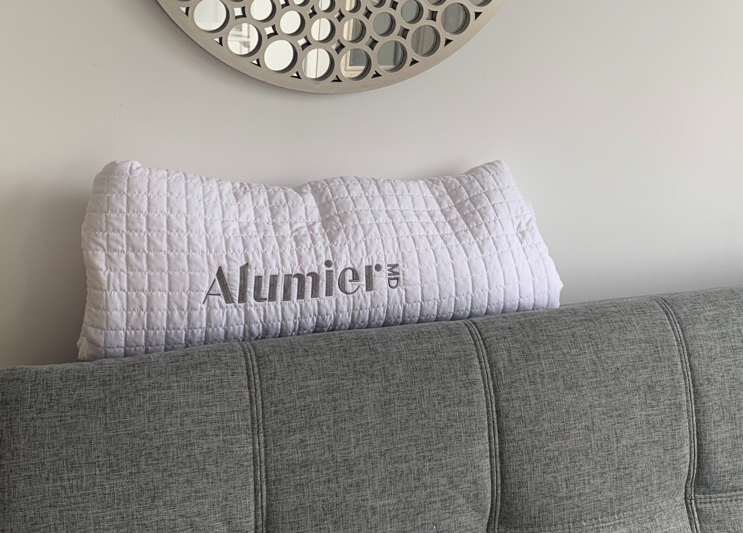 Elegant couch with a white quilt at The Peel Queen, Addlestone, England, GB. Perfect wellness ambiance.