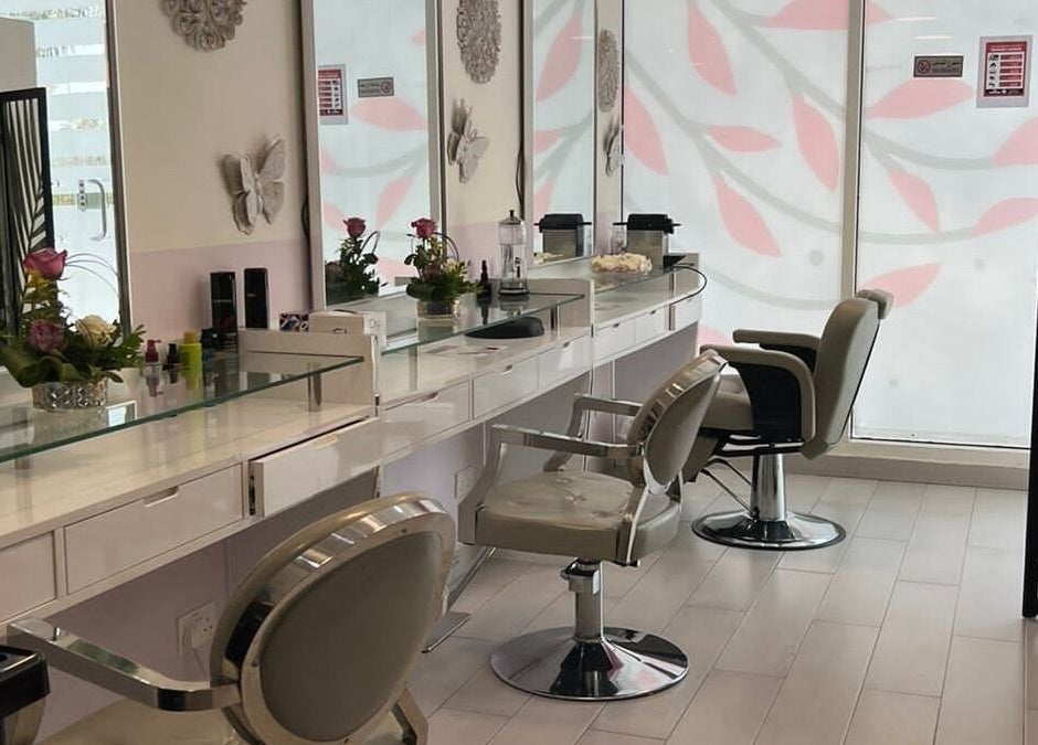 Elegant interior of Intime Ladies Salon, Dubai, featuring chic styling chairs and fresh florals.