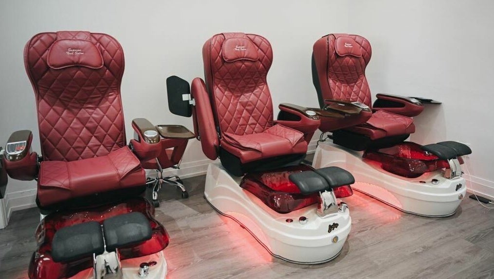 Elegant red pedicure chairs at Supreme Nail Spa in Toronto, Ontario, CA offering luxurious salon experience.