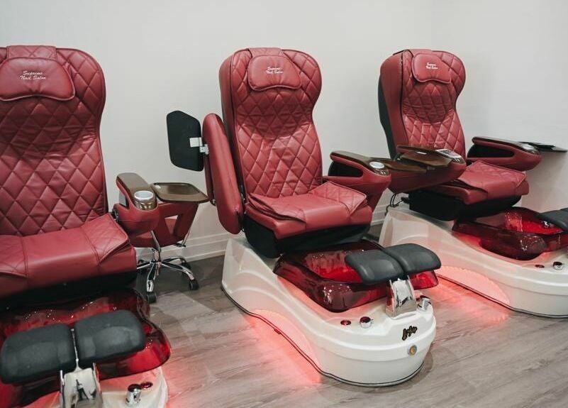 Elegant red pedicure chairs at Supreme Nail Spa in Toronto, Ontario, CA offering luxurious salon experience.