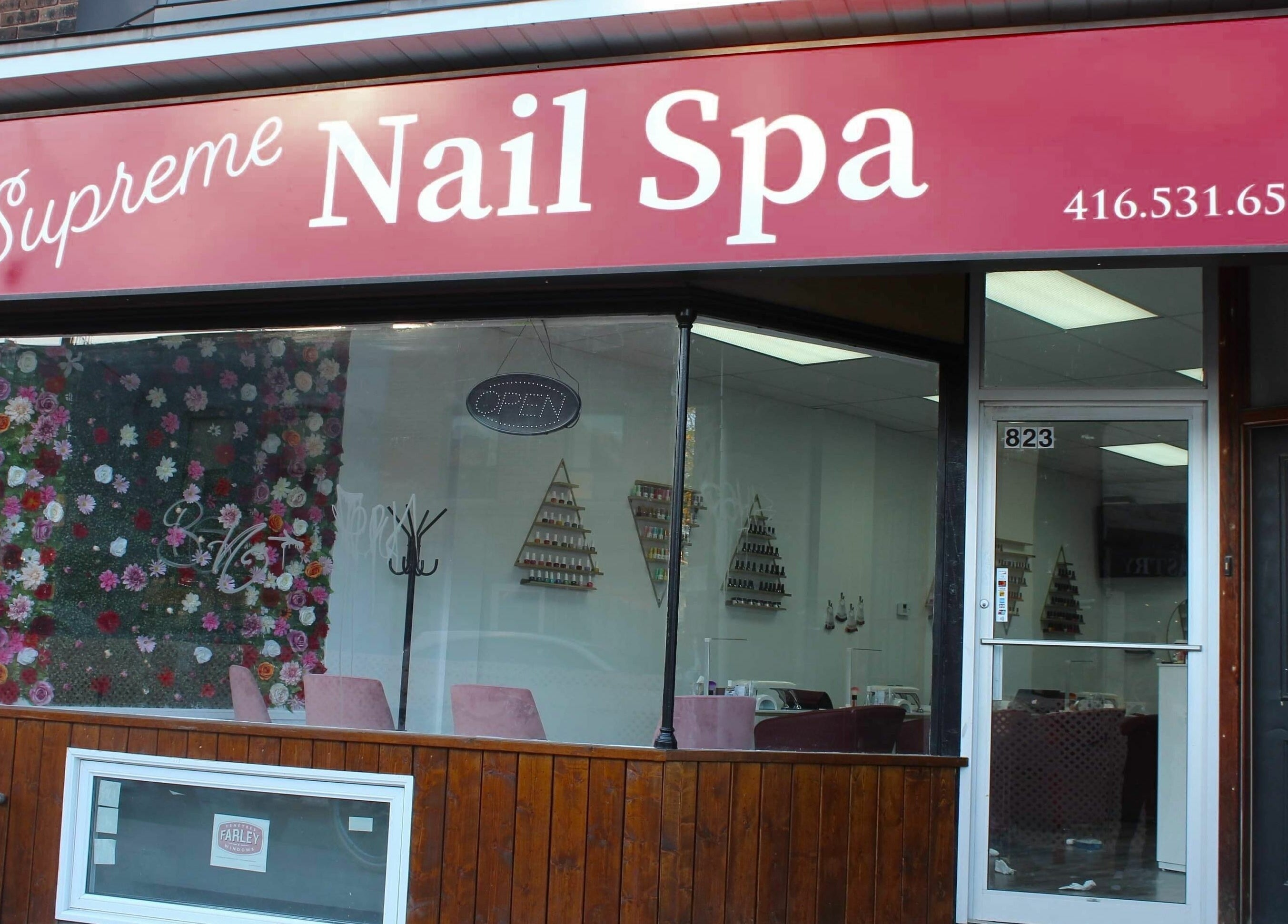 Exterior of Supreme Nail Spa in Toronto, Ontario, CA, showcasing its inviting entrance and floral decor.